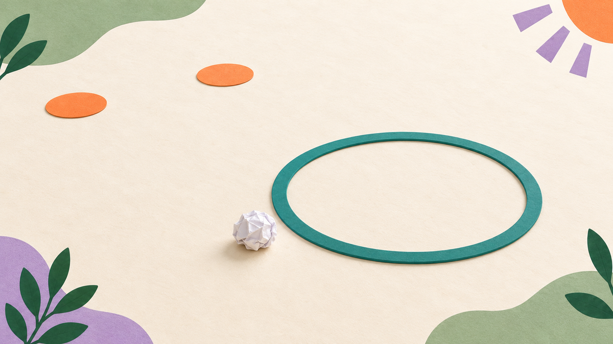A crumpled paper ball near a hoop target with two separate floor markers