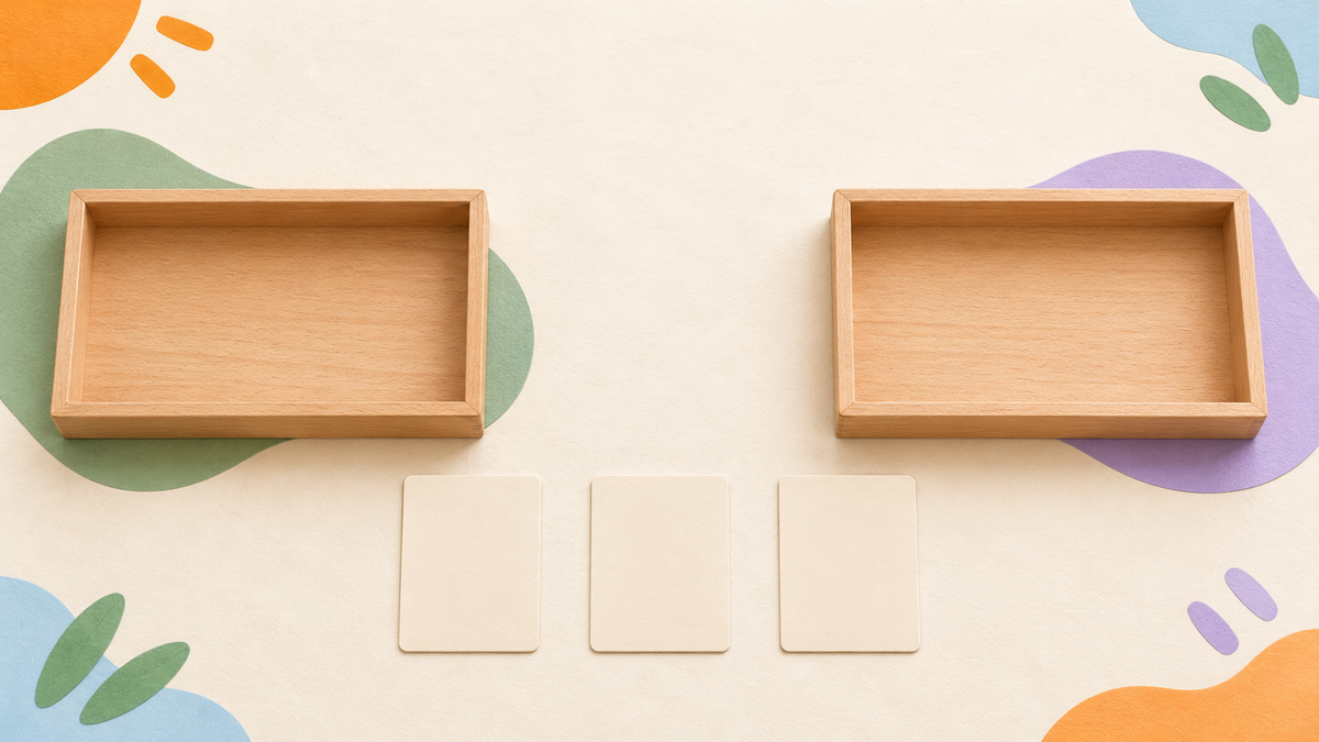 Two empty wooden sorting trays beside three face-down blank cards