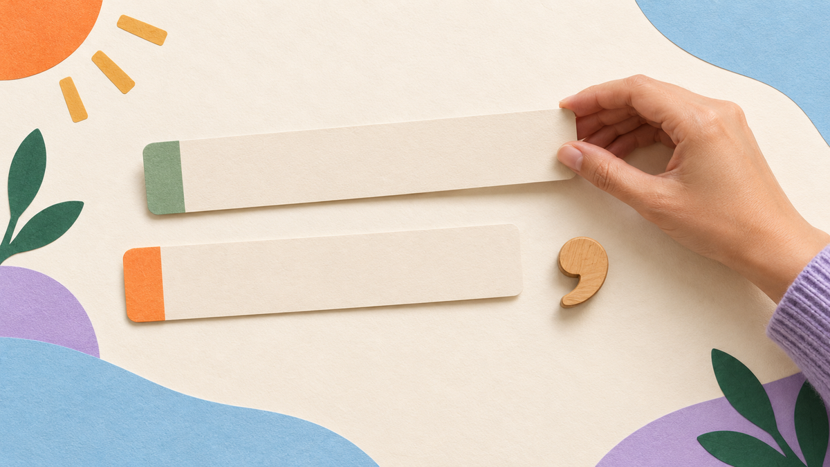 An adult hand rearranges two blank paper sentence strips beside a wooden comma-shaped teaching token.